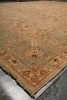 Load image into Gallery viewer, Close-up of a patterned rug with geometric designs on a concrete floor.