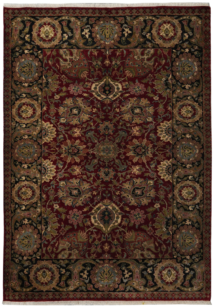 Decorative rug with intricate patterns in red, brown, and beige on a dark background