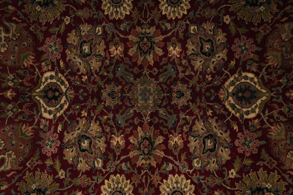 Close-up of a patterned rug with intricate designs on a dark background