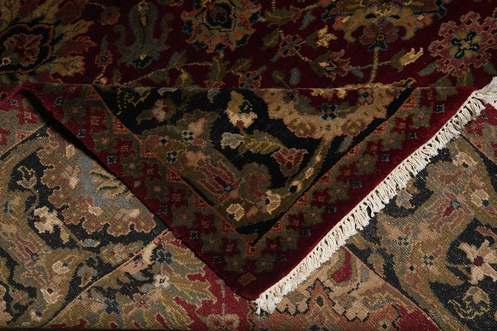Close-up of an ornate rug with intricate patterns and fringes.