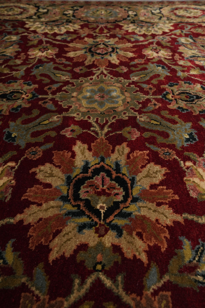 Close-up of a patterned red rug with intricate designs