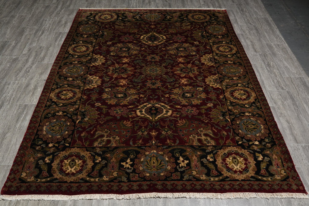 Decorative rug with intricate patterns on a gray floor