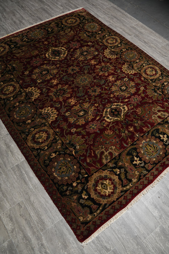 Decorative rug with intricate patterns on a wooden floor