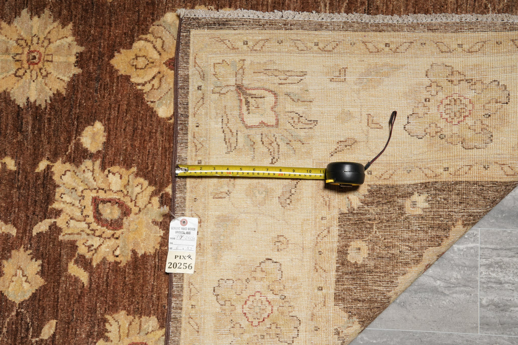 Two patterned rugs with a measuring tape and a tag on a wooden floor.