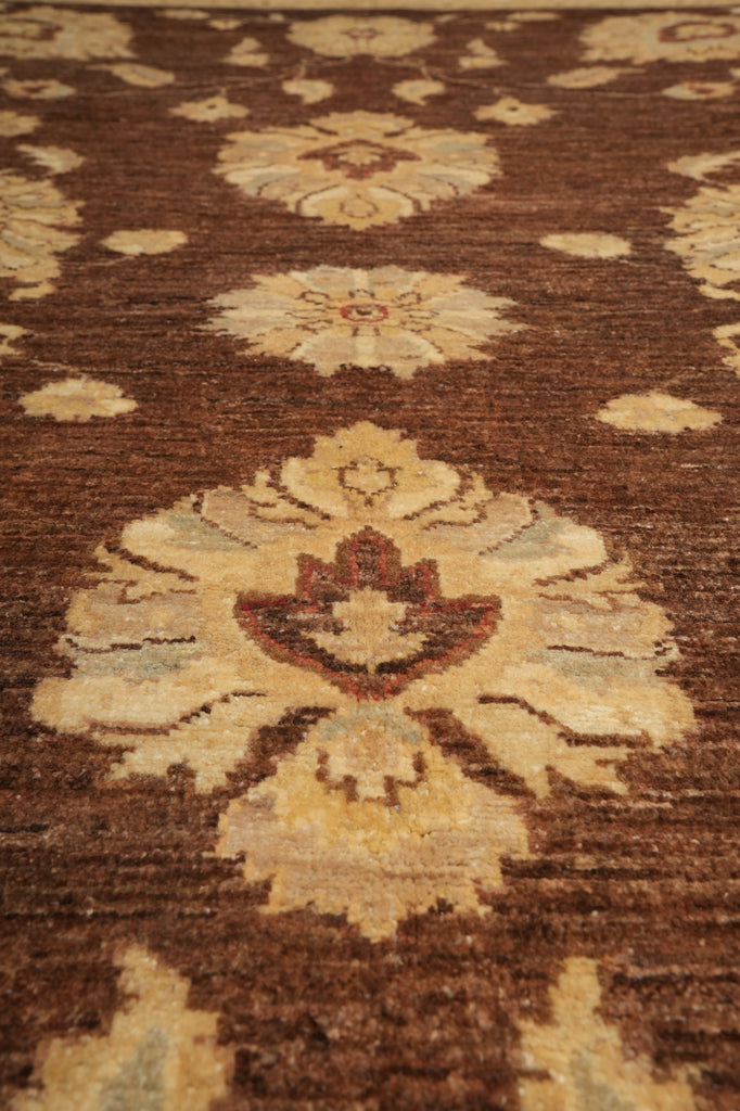 Close-up of a patterned rug with brown and beige colors