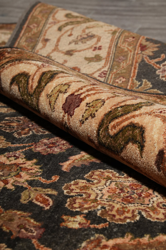 Close-up of patterned rugs with intricate designs on a neutral background