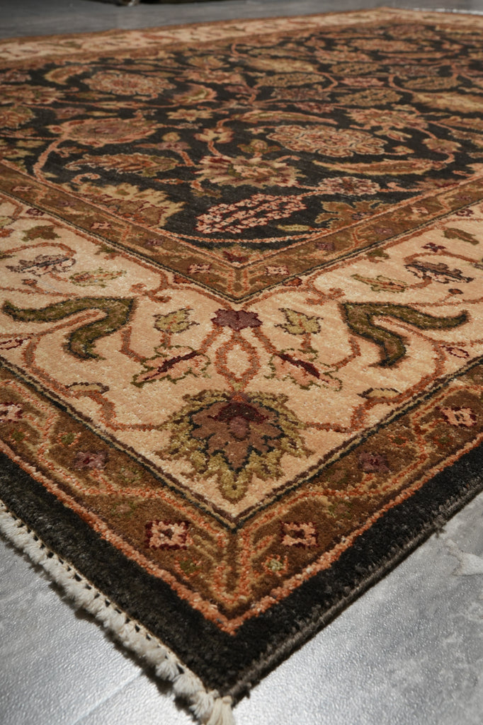 Close-up of a patterned rug with intricate designs on a neutral background