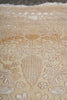 Load image into Gallery viewer, Close-up of a patterned rug with intricate designs on a beige background