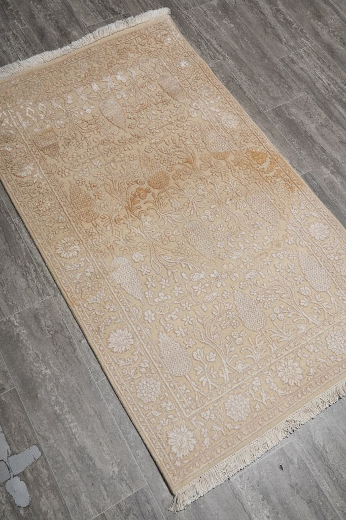 Beige patterned rug on a wooden floor