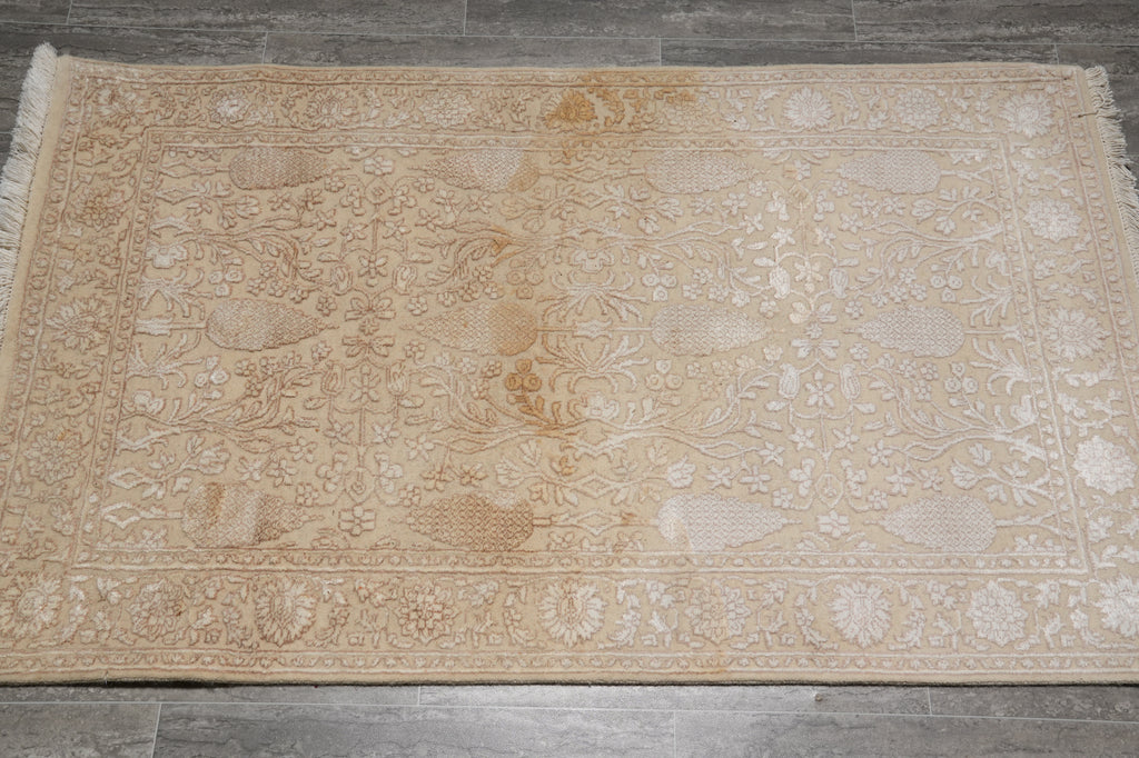 Beige patterned rug on a wooden floor