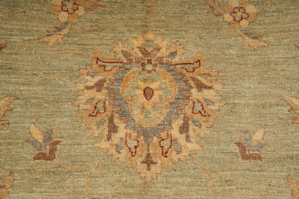 Close-up of a patterned rug with intricate designs on a green background