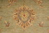 Load image into Gallery viewer, Close-up of a patterned rug with intricate designs on a green background
