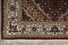 Load image into Gallery viewer, Close-up of a patterned rug with intricate designs and fringes.