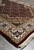 Load image into Gallery viewer, Close-up of a patterned rug with intricate designs on a plain background