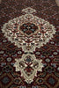 Load image into Gallery viewer, Close-up of a patterned rug with intricate designs.
