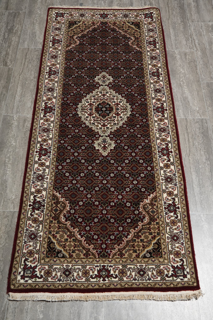 Decorative rug with intricate patterns on a gray floor