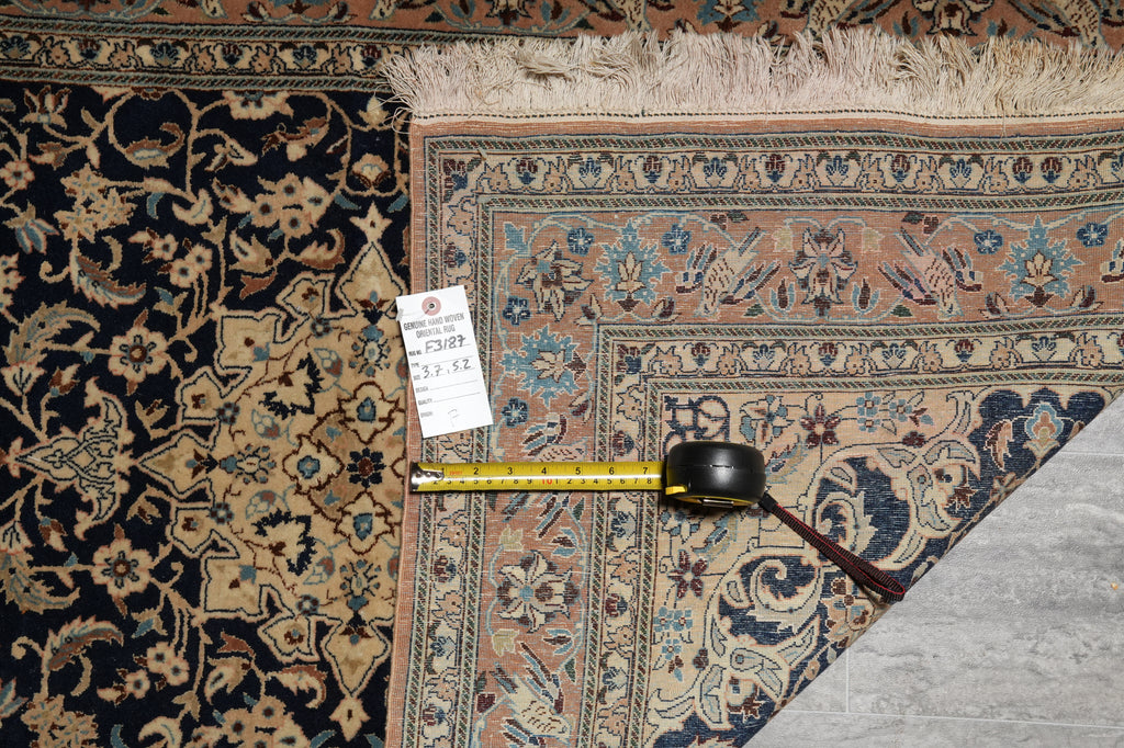 Two patterned rugs with a measuring tape on a gray surface