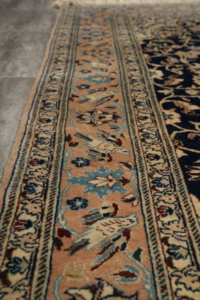 Close-up of an intricately patterned rug with detailed designs on a textured surface.