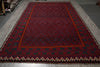 Load image into Gallery viewer, Red patterned rug on a gray floor