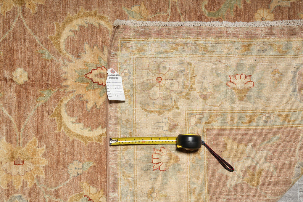 Patterned rug with a measuring tape and tag on a wooden floor.
