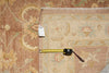 Load image into Gallery viewer, Patterned rug with a measuring tape and tag on a wooden floor.