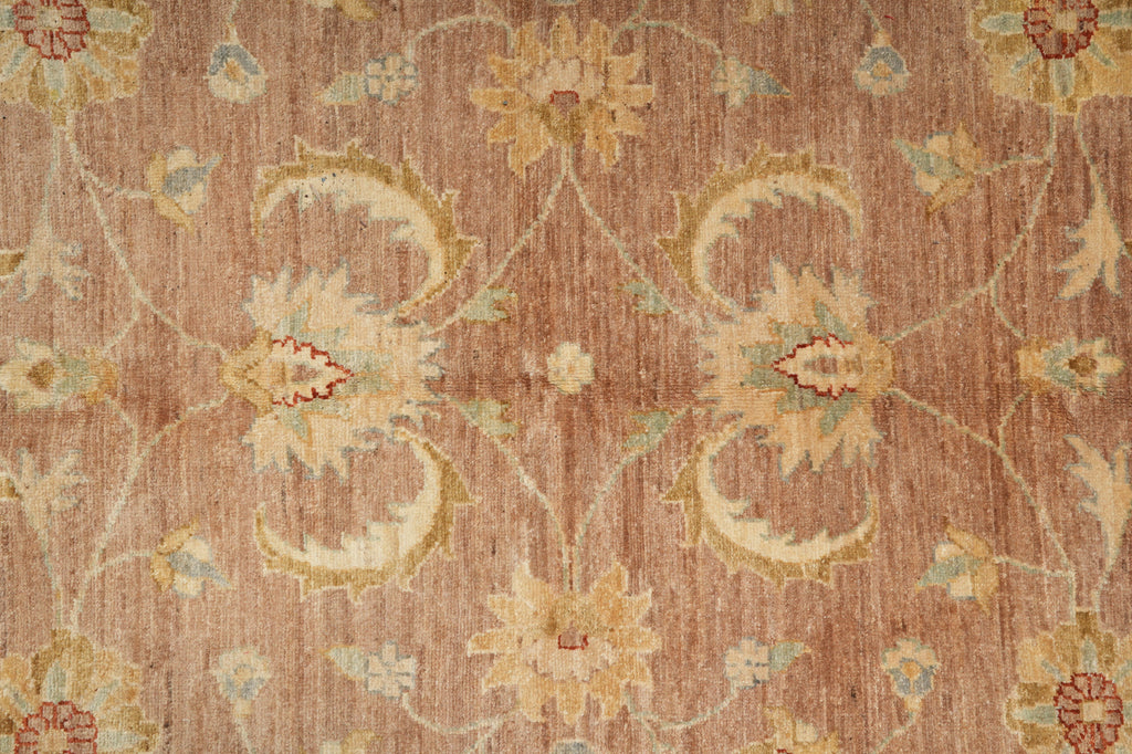 Close-up of a patterned rug with floral designs on a brown background