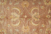 Load image into Gallery viewer, Close-up of a patterned rug with floral designs on a brown background