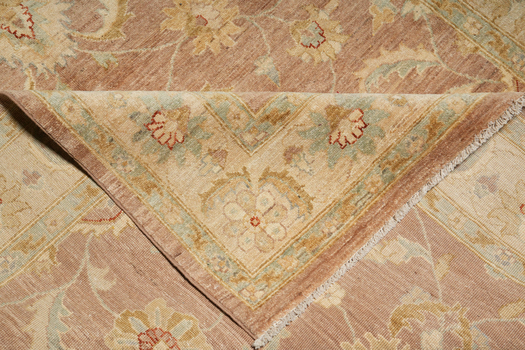 Close-up of a patterned rug with intricate designs in earthy tones.