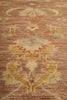Load image into Gallery viewer, Close-up of a patterned rug with floral designs on a brown background