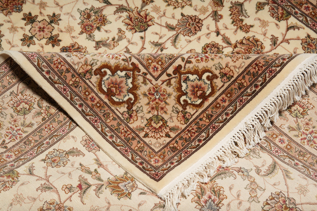 Close-up of a patterned rug with intricate designs and fringes.