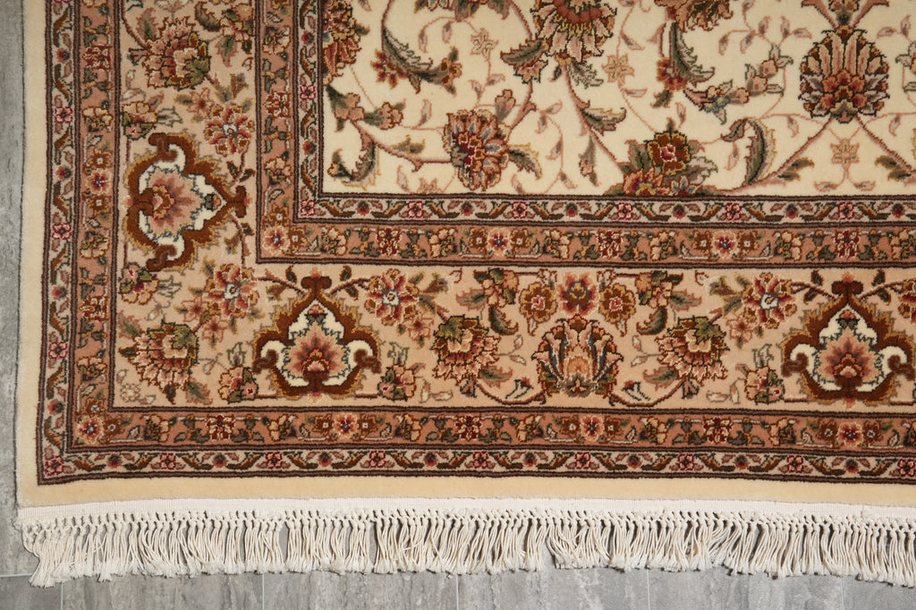 Close-up of a patterned rug with intricate designs on a neutral background