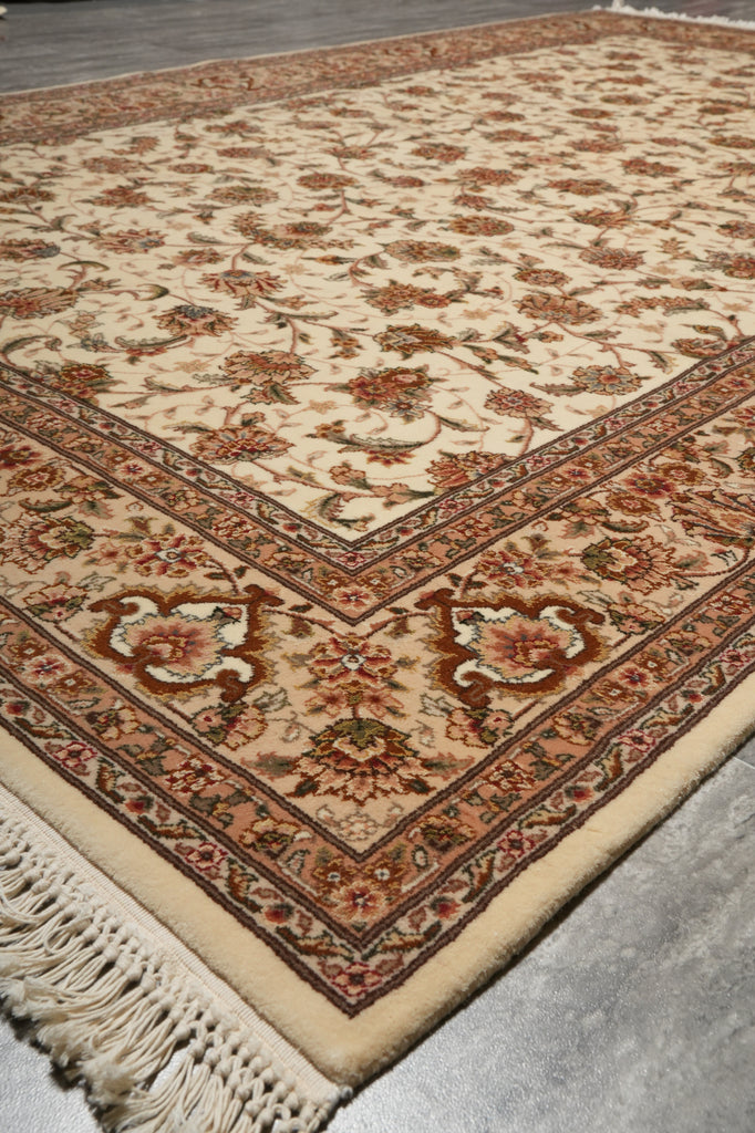 Close-up of a patterned rug with intricate designs on a neutral background