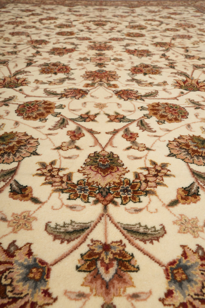 Close-up of a patterned rug with intricate designs on a beige background