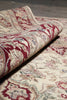 Load image into Gallery viewer, Close-up of a patterned rug with red and beige colors.