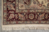Load image into Gallery viewer, Close-up of a patterned rug with floral designs on a gray floor.