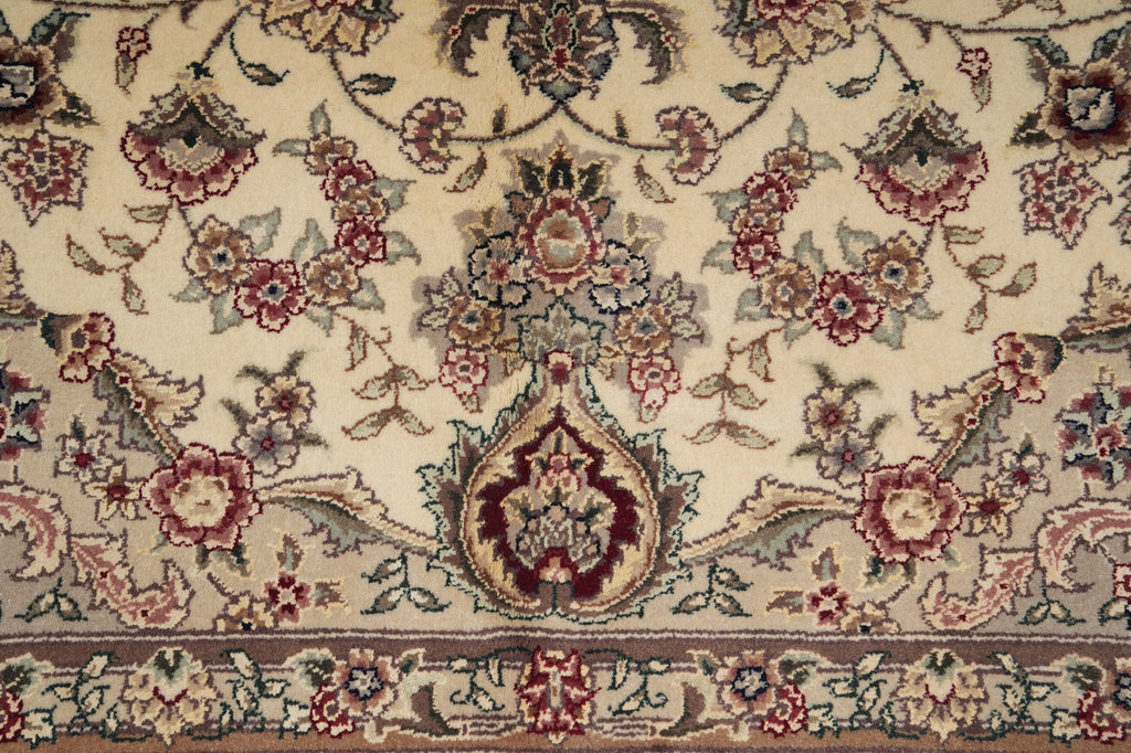 Close-up of a patterned rug with floral and paisley designs.