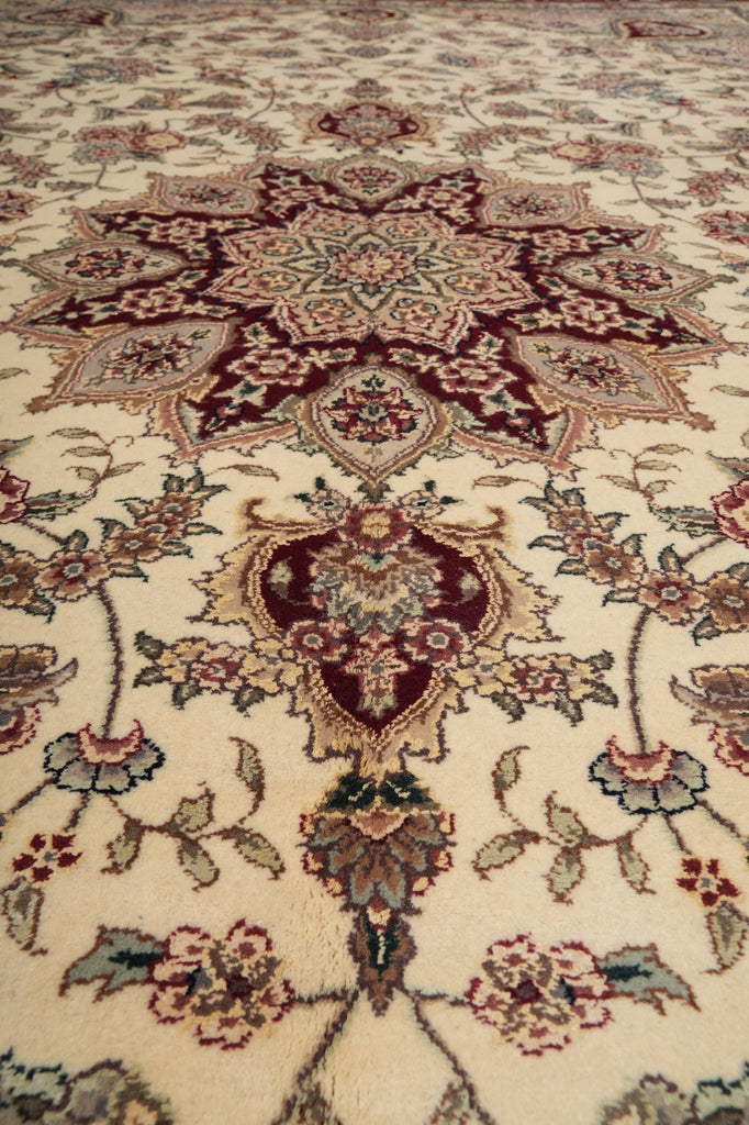 Close-up of a patterned rug with intricate designs on a beige background