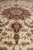 Load image into Gallery viewer, Close-up of a patterned rug with intricate designs on a beige background