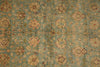 Load image into Gallery viewer, Close-up of a patterned rug with floral designs on a teal background