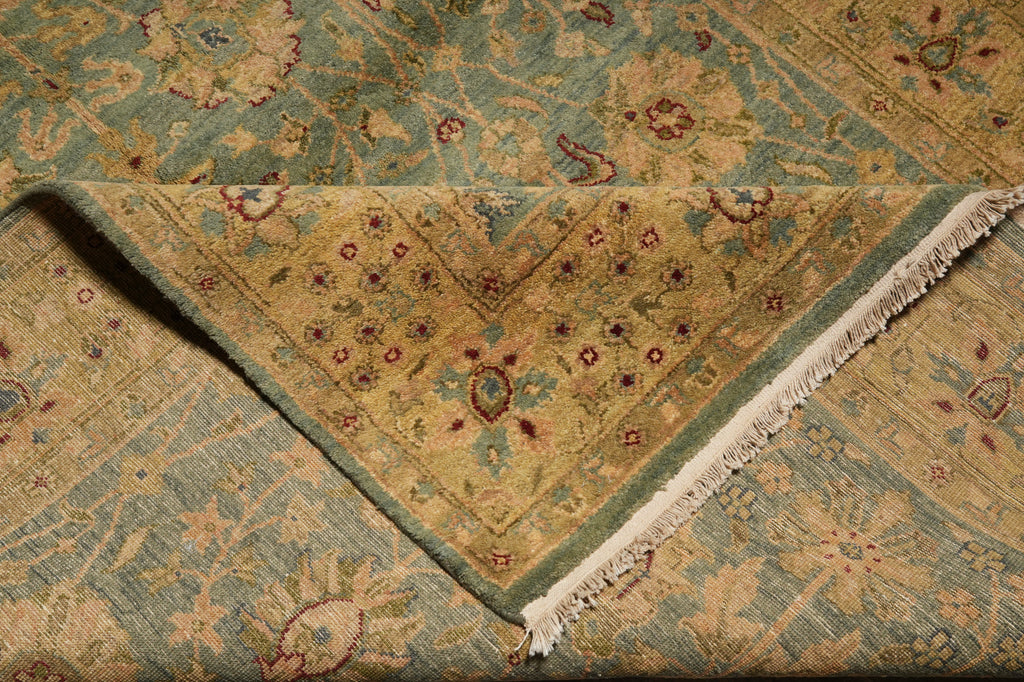 Close-up of a patterned rug with green and brown colors
