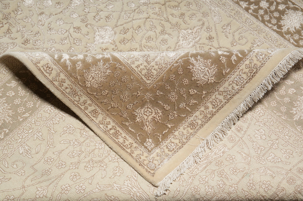 Close-up of a beige and brown patterned rug with intricate designs.