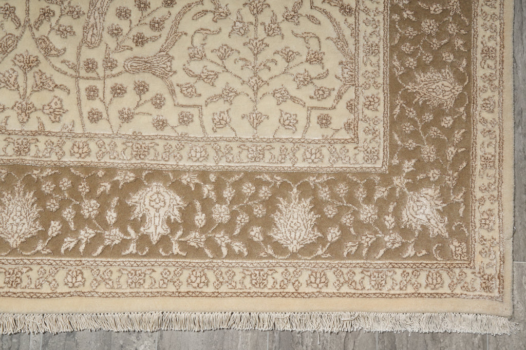 Close-up of a patterned beige rug on a wooden floor