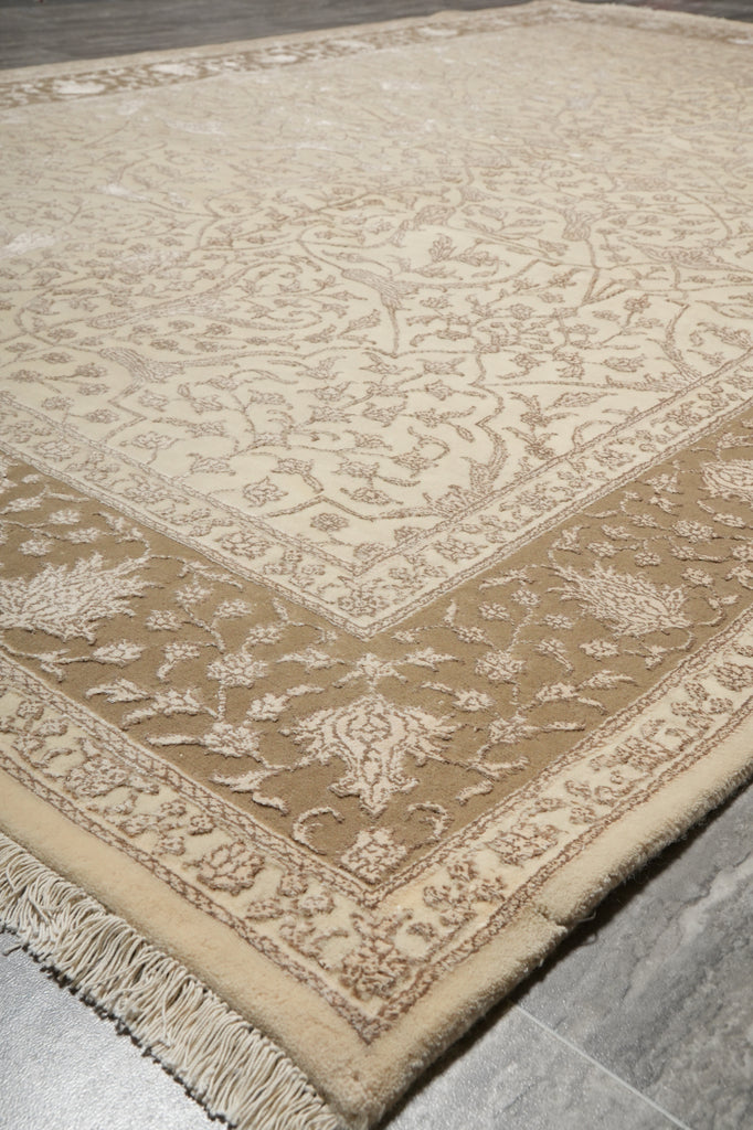Patterned beige and white rug on a gray floor