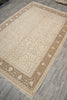 Load image into Gallery viewer, Beige patterned rug on a wooden floor