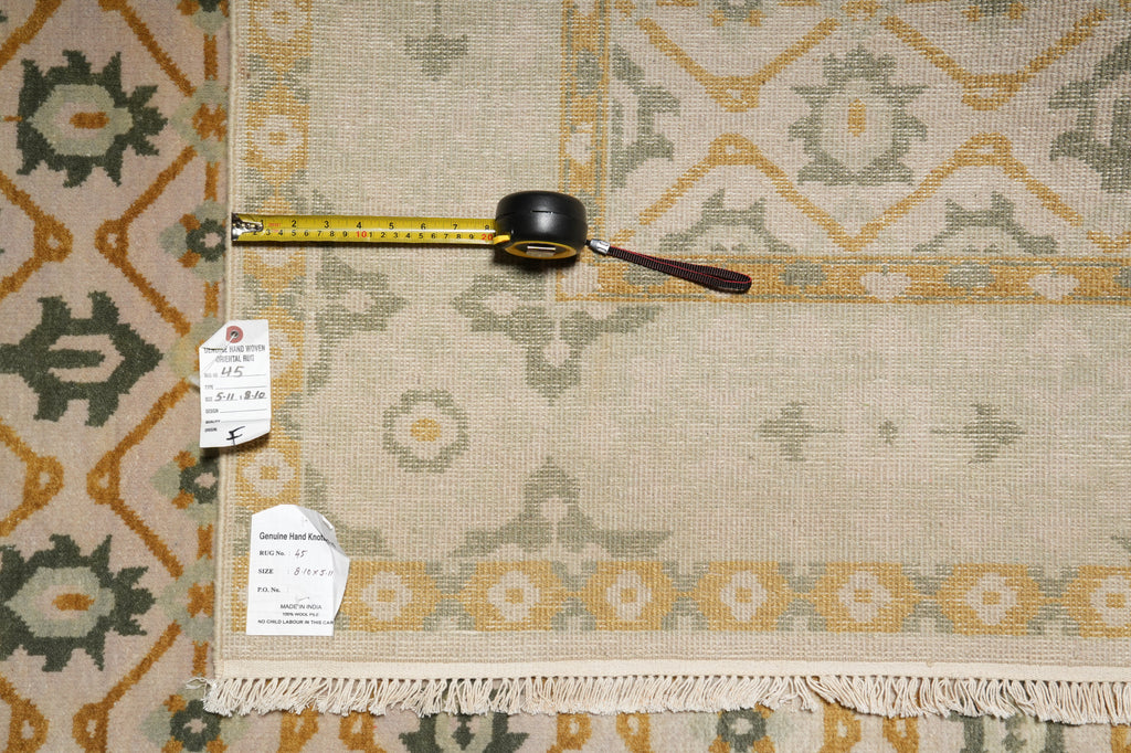 Decorative rug with geometric pattern, measuring tape, and price tag on a plain background
