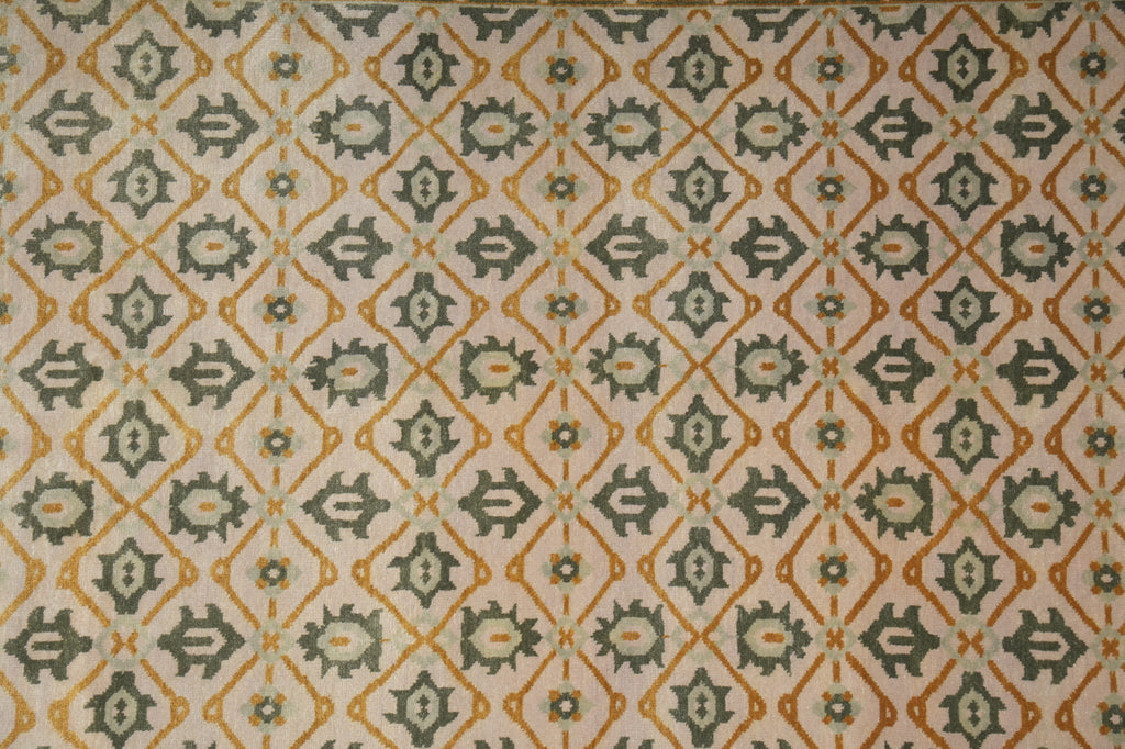 Patterned fabric with geometric design in green, orange, and beige.