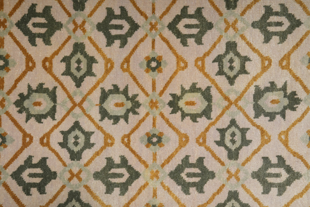 Patterned fabric with geometric design in green, orange, and beige.