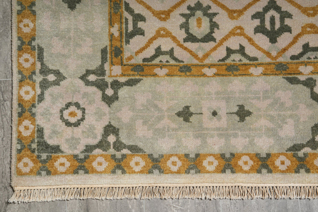 Close-up of a patterned rug with geometric designs on a gray surface