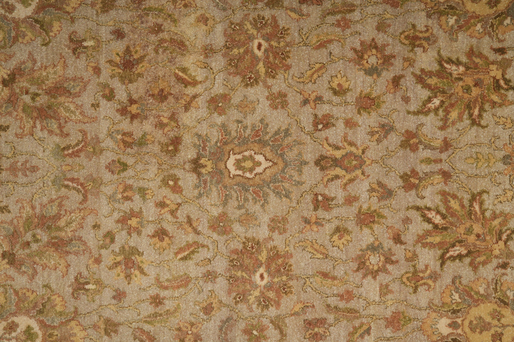 Close-up of a patterned rug with intricate designs in earthy tones.