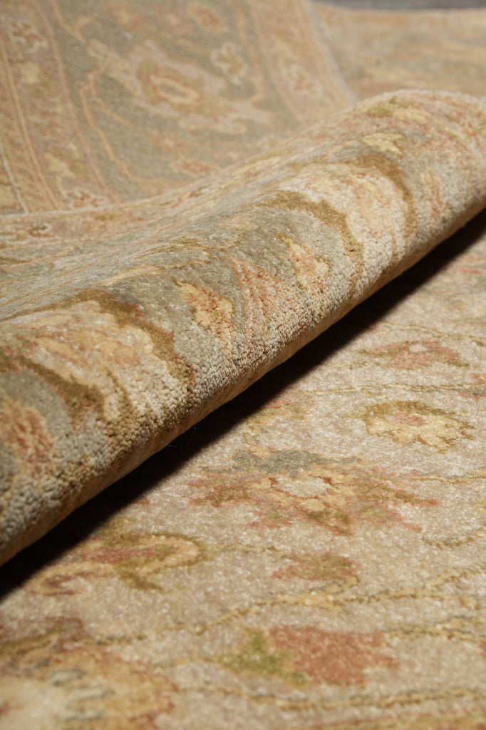 Close-up of textured fabric with intricate patterns in beige, brown, and green.